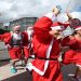 Some of the 4000 Santa's that took part in the Variety Santa Run cross the finish line at The Sydney Opera House, today.