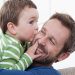 Germany, Bavaria, Munich, Son (2-3 Years) kissing his father, smiling