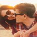 Smiling hipster couple in love woman embraces a man in sunny day