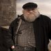 In this publicity image released by HBO, author George R.R. Martin whose novel series have been adapted into the HBO series "Game of Thrones," is shown on the set. (AP Photo/HBO, Nick Briggs )