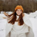 woman in winter clothes in a hat fun winter landscape There is a lot of snow around. High quality photo