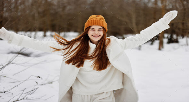 woman in winter clothes in a hat fun winter landscape There is a lot of snow around. High quality photo