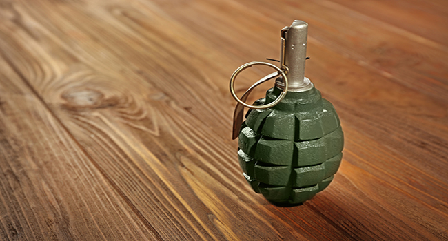Close up view of hand grenade on wooden background